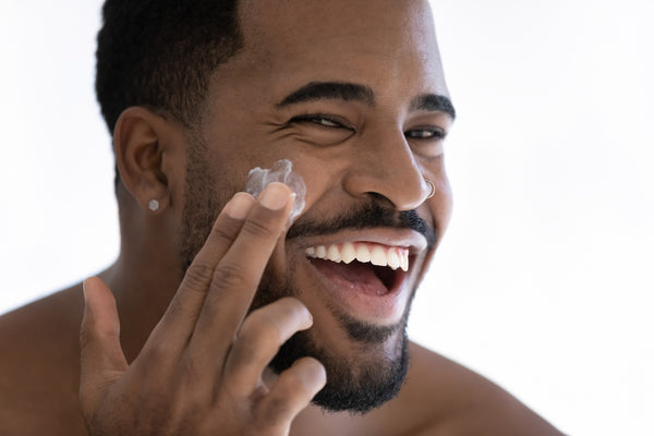 Black man using ML Delicate Beauty retinol facial skincare